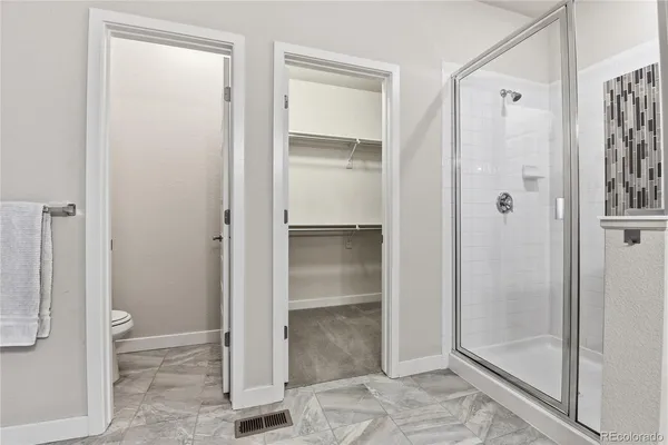 a bathroom with a glass shower door