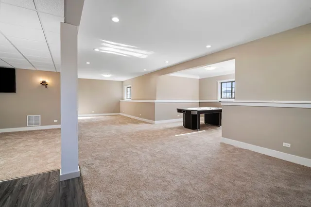 a kitchen with stainless steel appliances a refrigerator and wooden floor