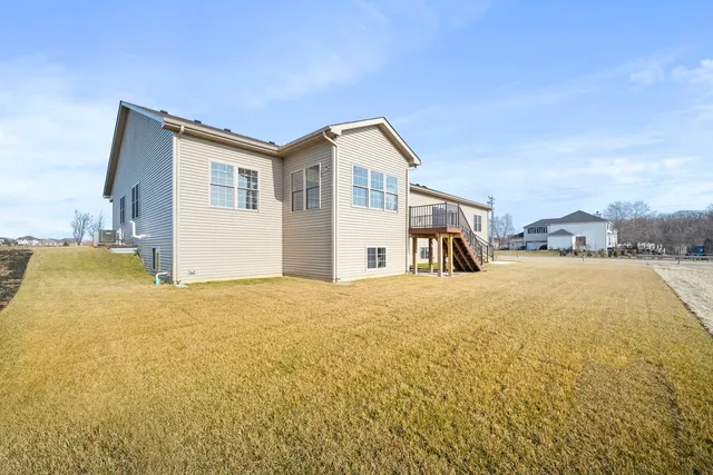 a view of a balcony with wooden floor and outdoor seating