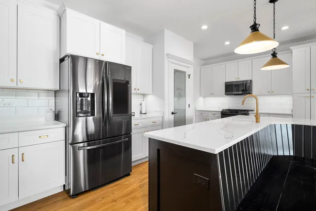 a kitchen with stainless steel appliances a stove a microwave and cabinets
