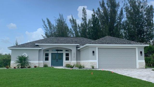 6375 Ceres Street Englewood, FL 34224 - Photo 8 of 14 a front view of a house with a yard and garage