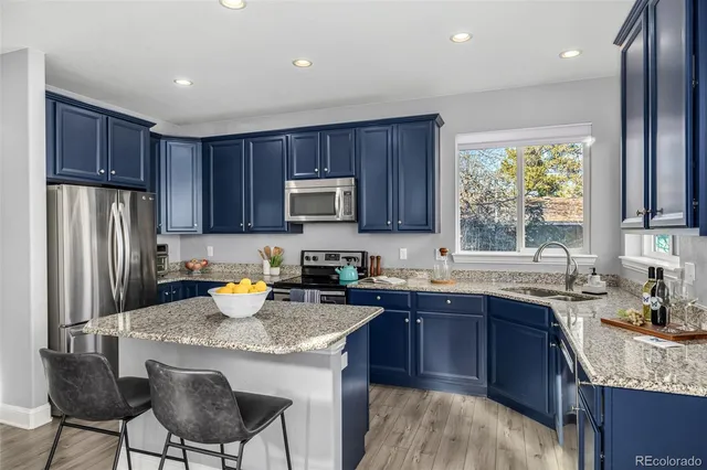 a kitchen with a sink stove and refrigerator