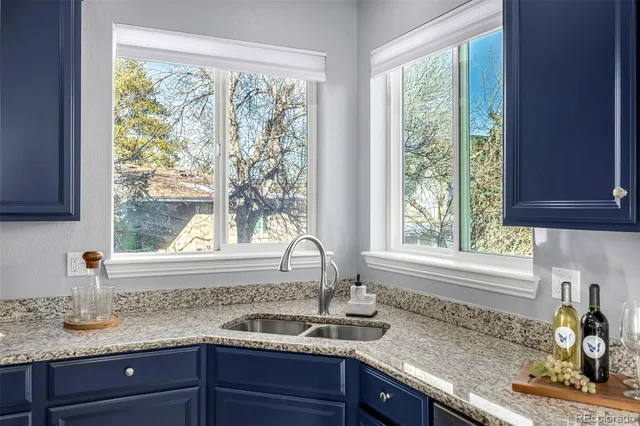 a kitchen with granite countertop a sink and a window
