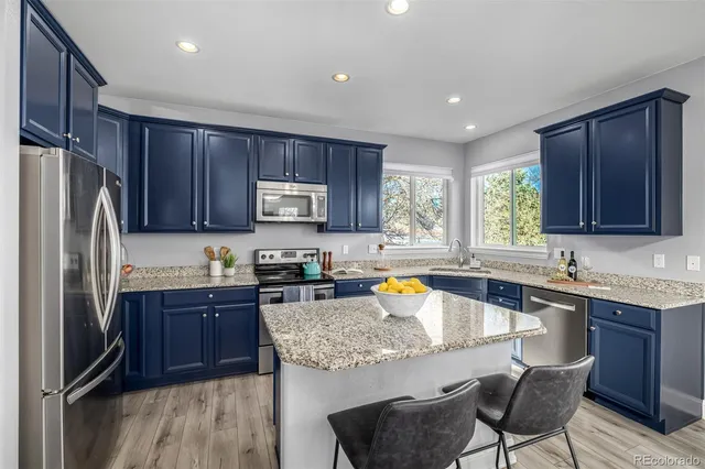 a kitchen with a sink stove and refrigerator