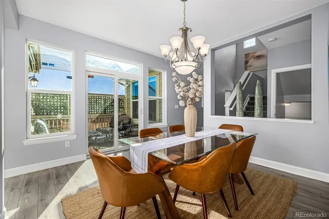 a view of a dining room with furniture wooden floor and chandelier