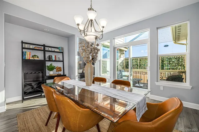a dining room with furniture a chandelier and window