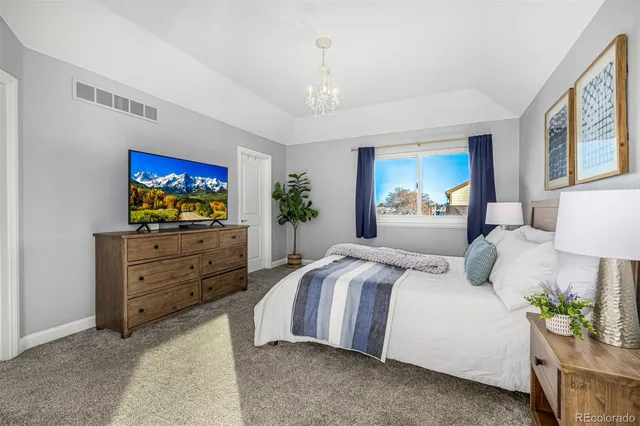 a bedroom with a bed and a flat screen television