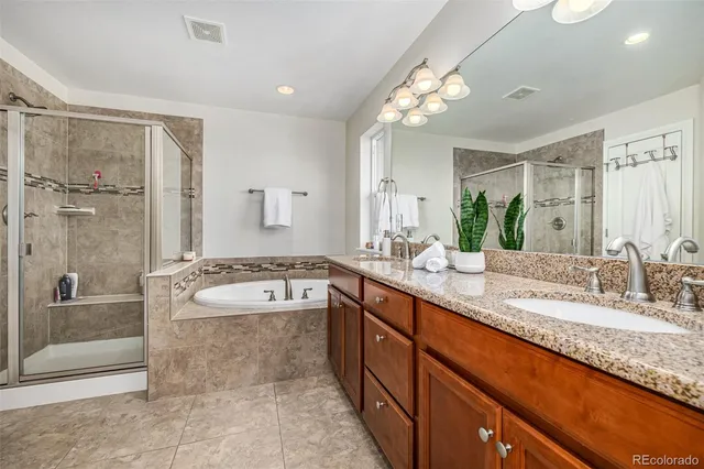 a spacious bathroom with a granite countertop tub sink and mirror