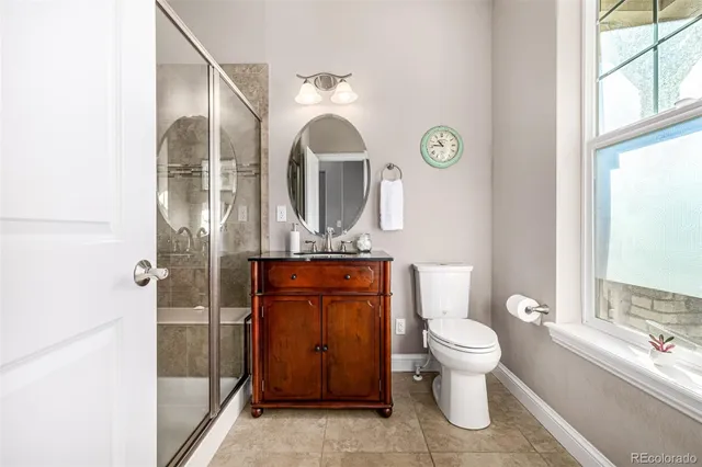 a bathroom with a toilet a sink and a mirror