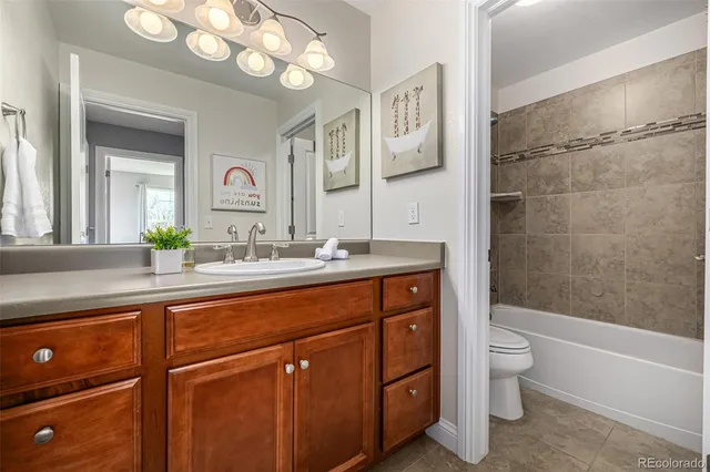 a bathroom with a sink a toilet and bathtub