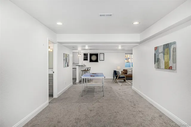 a living room with furniture potted plant and a window