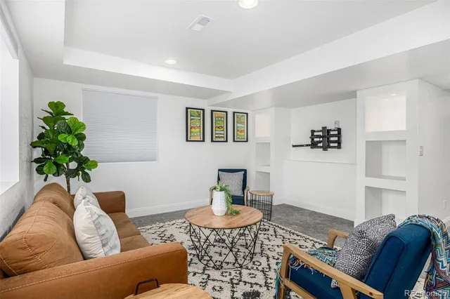 a view of a kitchen with granite countertop a stove a sink and a potted plant