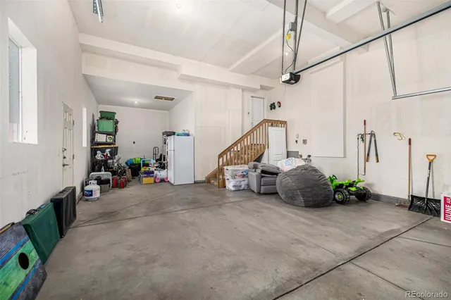 a roof deck with a couch and chairs