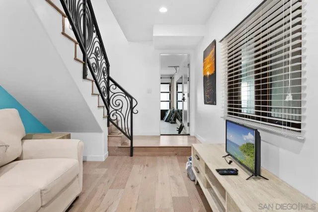 a living room with furniture a rug and a flat screen tv