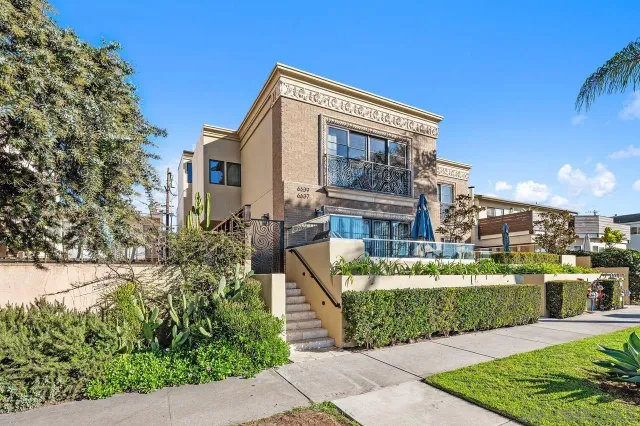 a living room with furniture and stairs with wooden floor