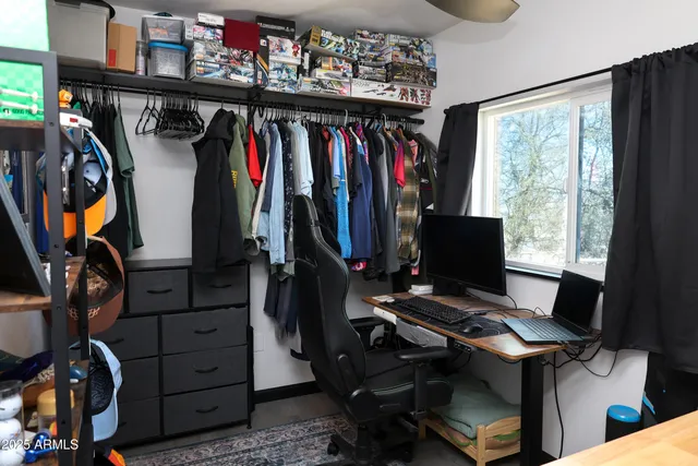 a view of walk in closet with clothes and shoes