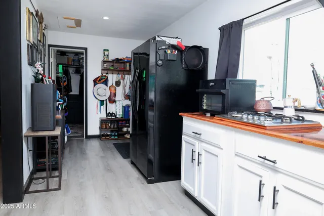 a kitchen with stainless steel appliances granite countertop a refrigerator and a stove
