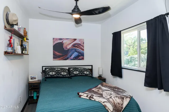 a bedroom with a bed and a window