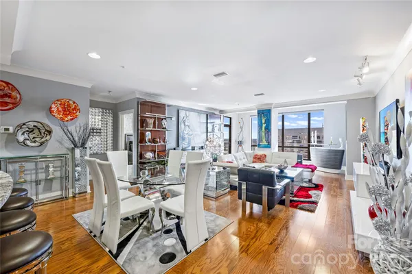 a living room with furniture and a wooden floor
