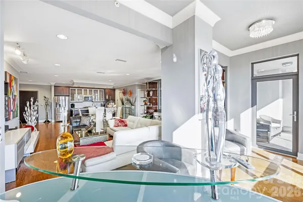 a living room with lots of furniture and white walls
