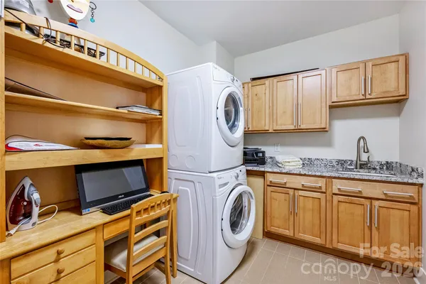 a utility room with sink dryer and washer