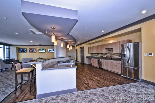 a kitchen with stainless steel appliances kitchen island granite countertop a sink counter space and cabinets