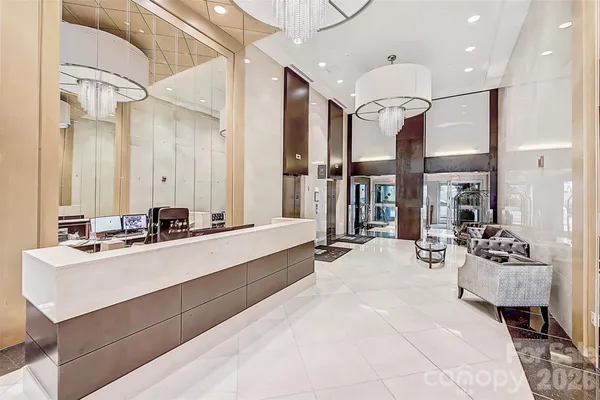 a large white kitchen with a large window and stainless steel appliances