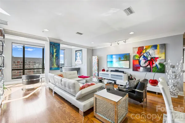 a bedroom with furniture and a flat screen tv