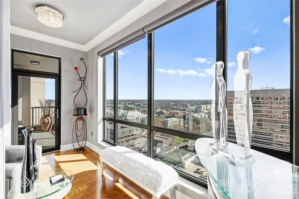 a bedroom with furniture and large windows