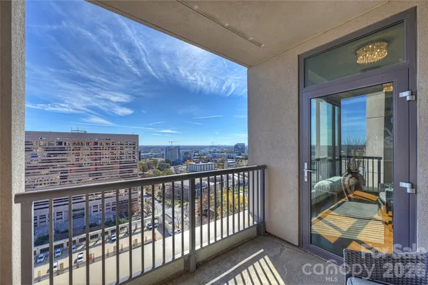 a view of a balcony with wooden floor and fence