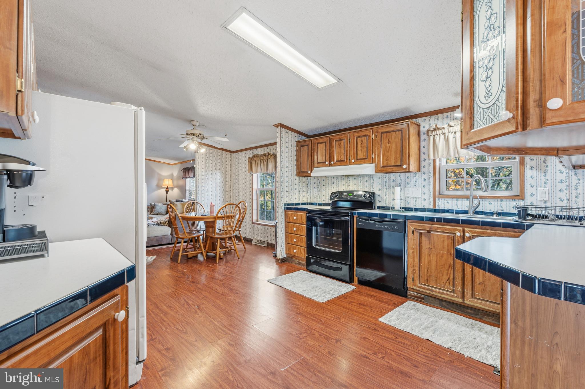 1834 Emily Drive Edgewood, MD 21040 - Photo 16 of 42 a kitchen with stainless steel appliances kitchen island granite countertop wooden floors and a stove top oven