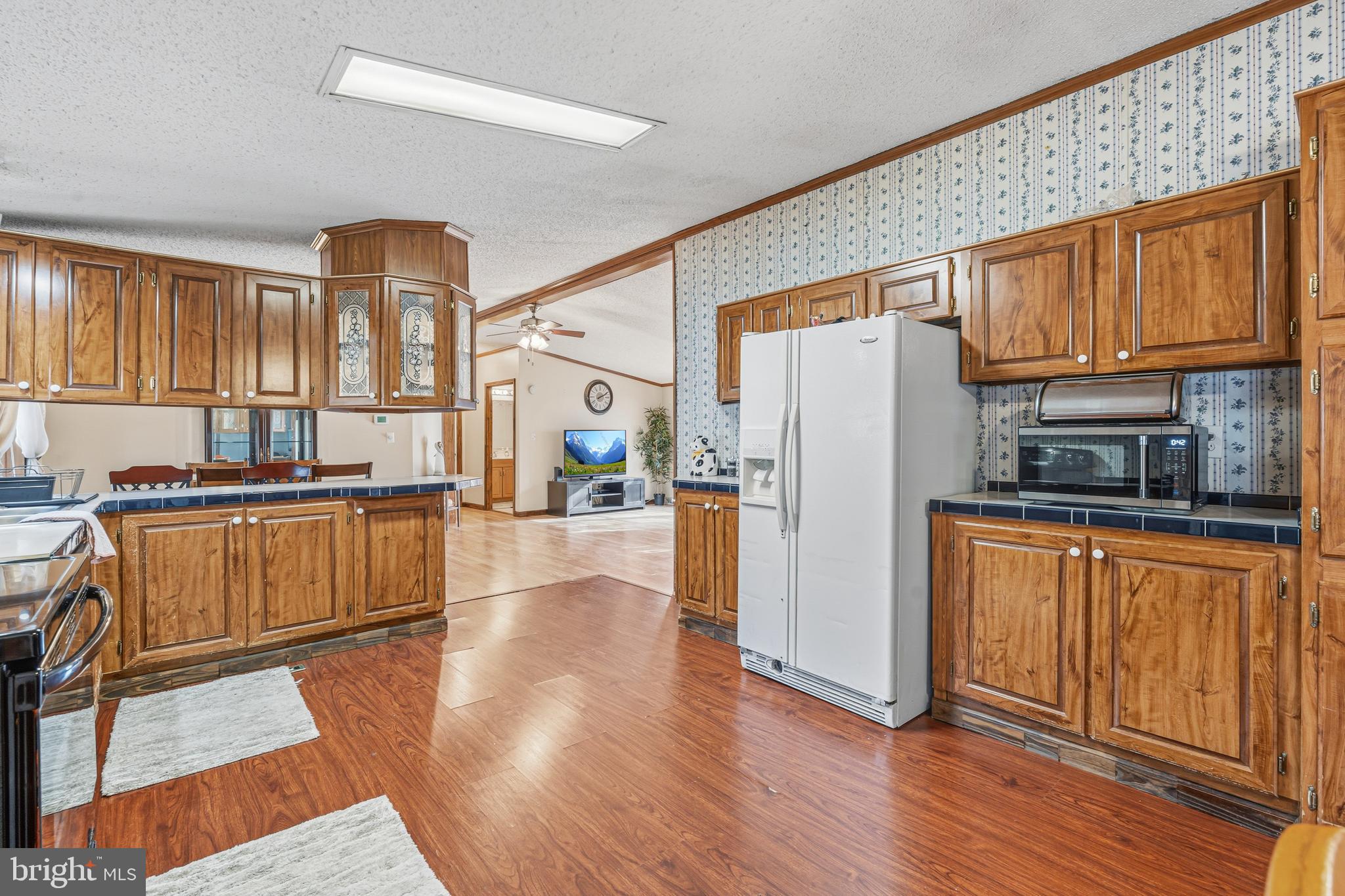 1834 Emily Drive Edgewood, MD 21040 - Photo 17 of 42 a kitchen with stainless steel appliances granite countertop a refrigerator a stove a sink dishwasher and wooden cabinets with wooden floor