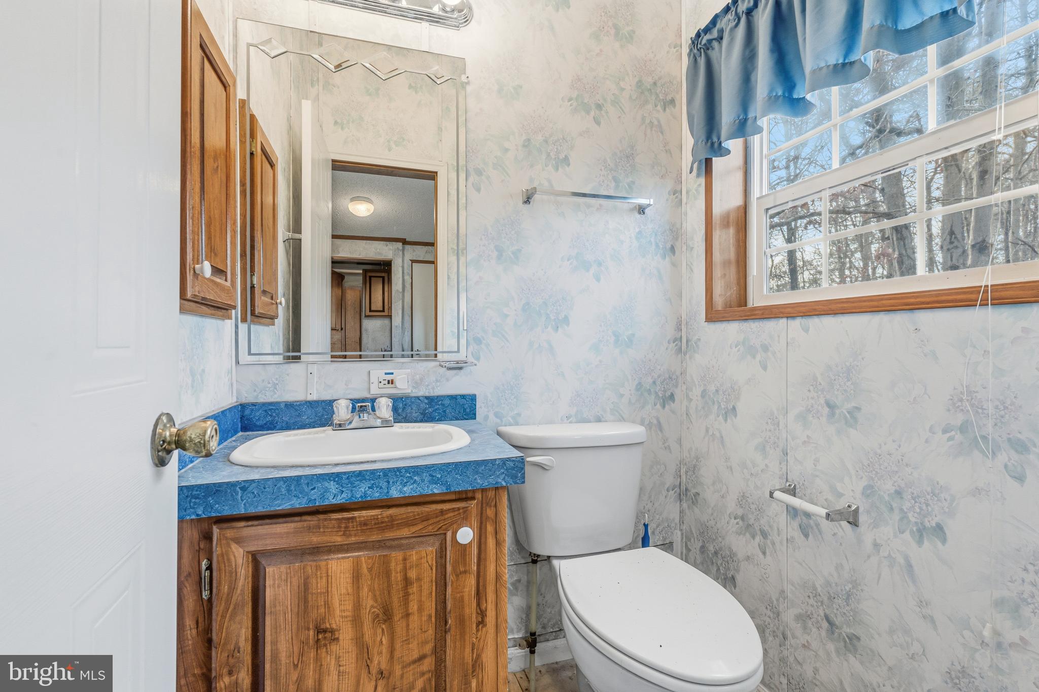 1834 Emily Drive Edgewood, MD 21040 - Photo 29 of 42 a bathroom with a granite countertop toilet sink and mirror