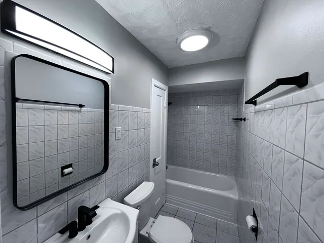 a bathroom with a toilet and shower