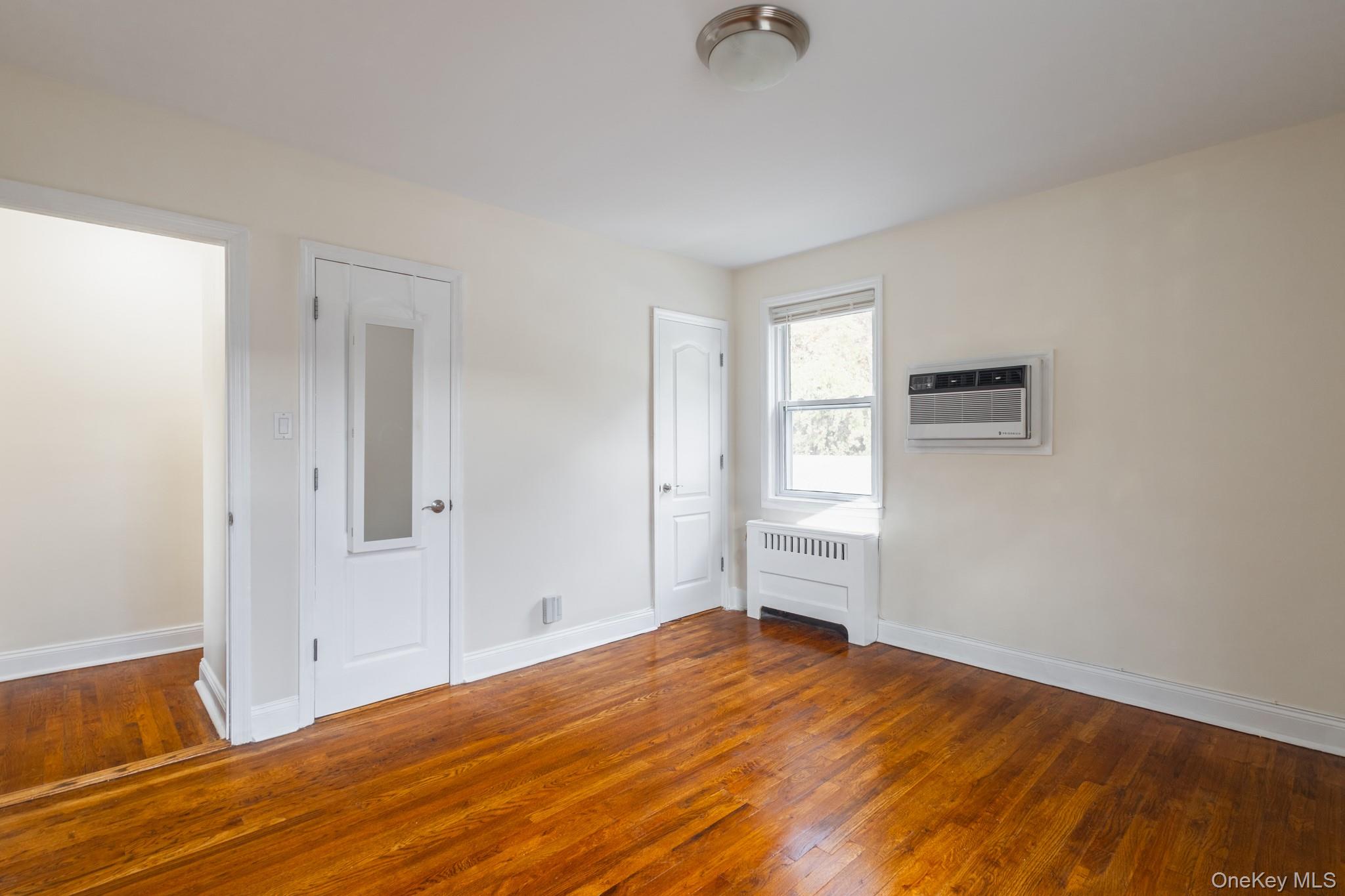 251-41 71st Road, Unit 54B Queens, NY 11426 - Photo 15 of 20 a view of empty room with wooden floor and fan