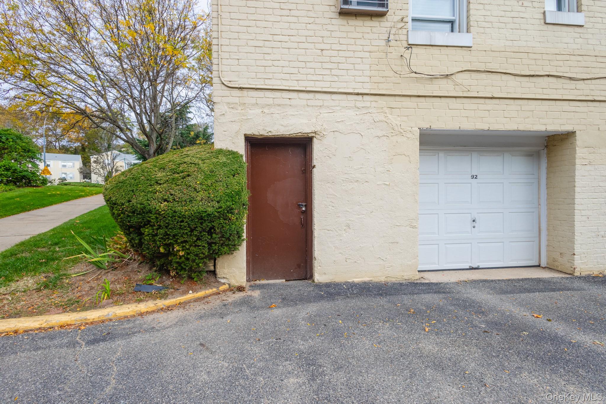 251-41 71st Road, Unit 54B Queens, NY 11426 - Photo 20 of 20 front view of a house with a yard