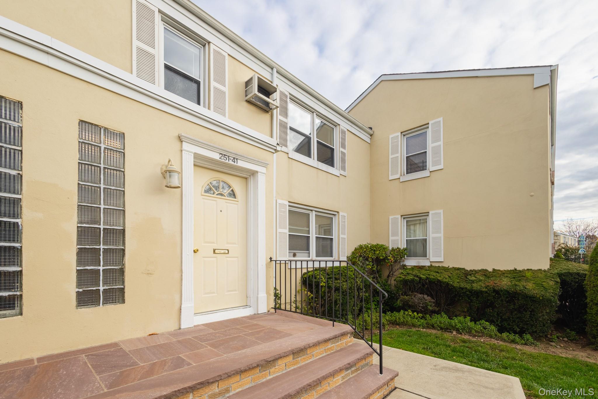 251-41 71st Road, Unit 54B Queens, NY 11426 - Photo 2 of 20 a front view of a house with a yard