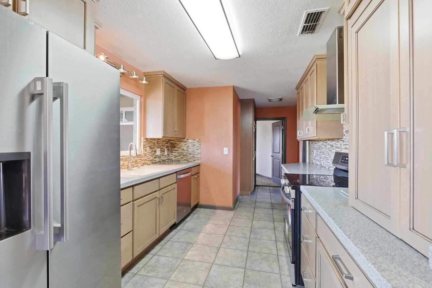 4224 Griffin Road Hughson, CA 95326 - Photo 11 of 46 a large bathroom with a granite countertop double vanity sink a mirror and a shower