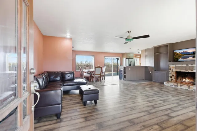 a living room with fireplace furniture and a wooden floor