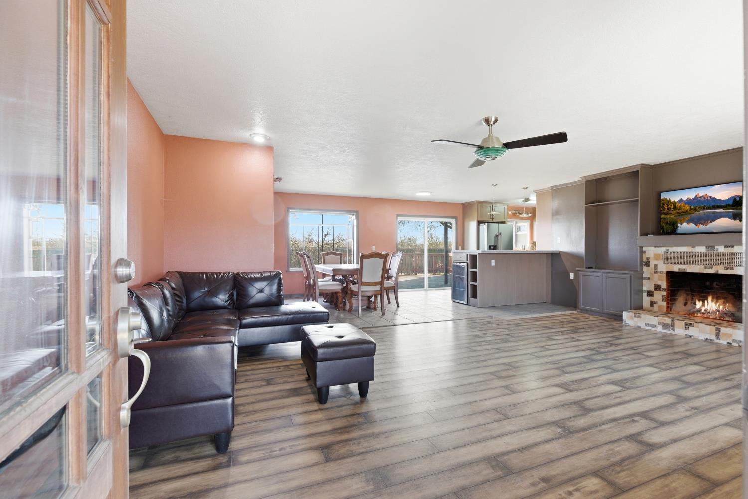 4224 Griffin Road Hughson, CA 95326 - Photo 16 of 46 a living room with fireplace furniture and a wooden floor