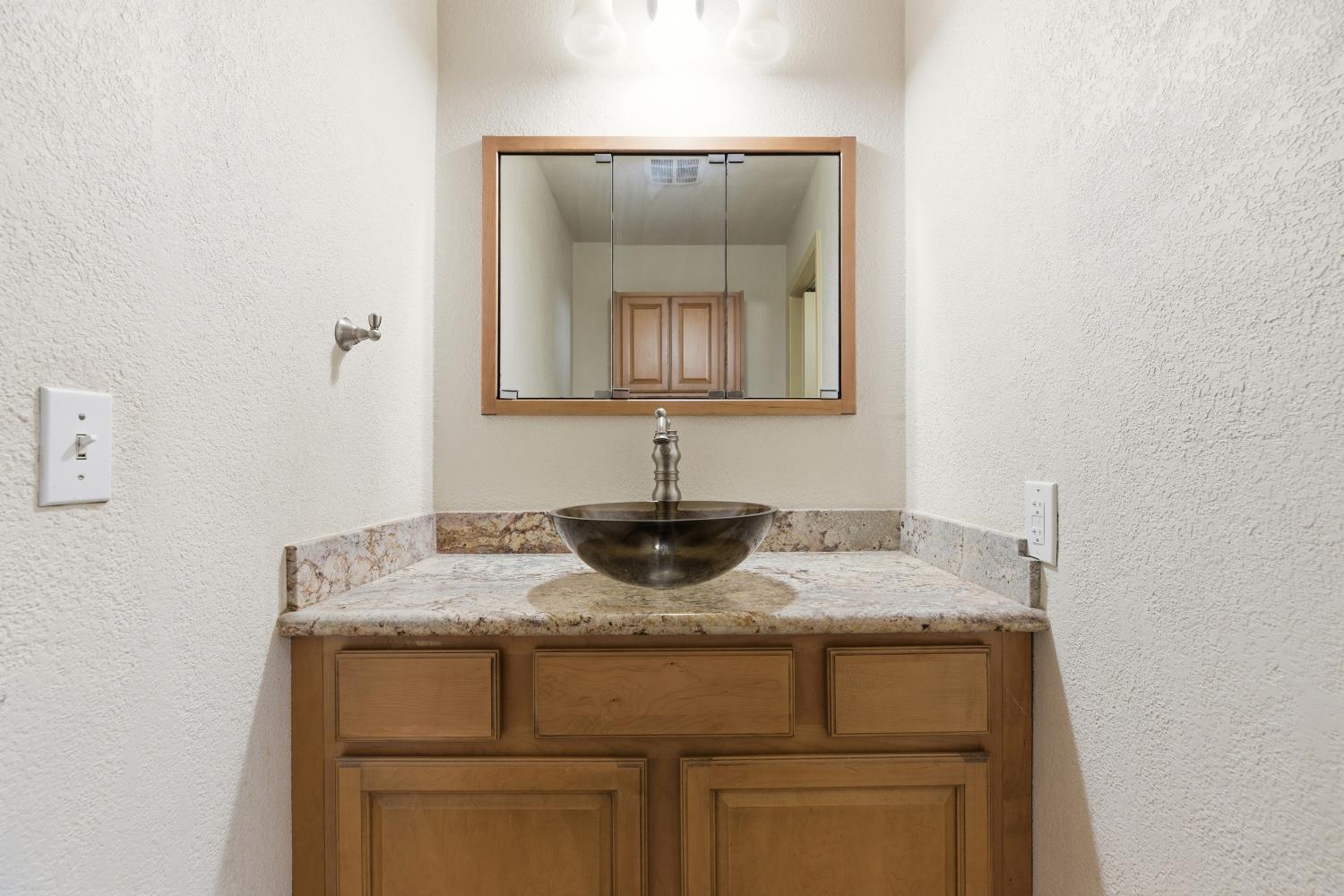 4224 Griffin Road Hughson, CA 95326 - Photo 17 of 46 a bathroom with a granite countertop sink and a mirror