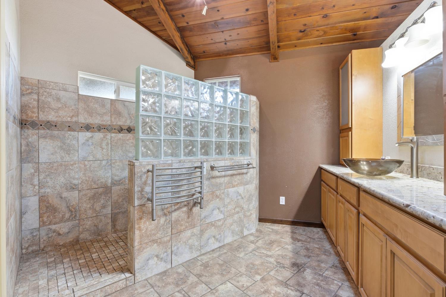 4224 Griffin Road Hughson, CA 95326 - Photo 19 of 46 a bathroom with a granite countertop shower a sink and a toilet
