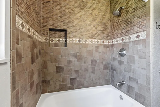 a bathroom with a bathtub and shower