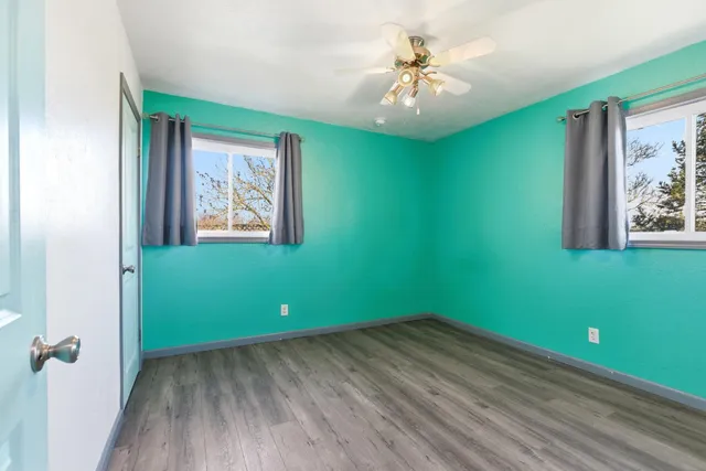 an empty room with windows and closet