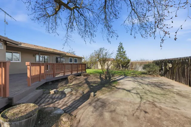 a backyard of a house with wooden fence