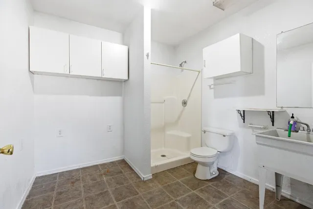 a bathroom with a toilet and a shower