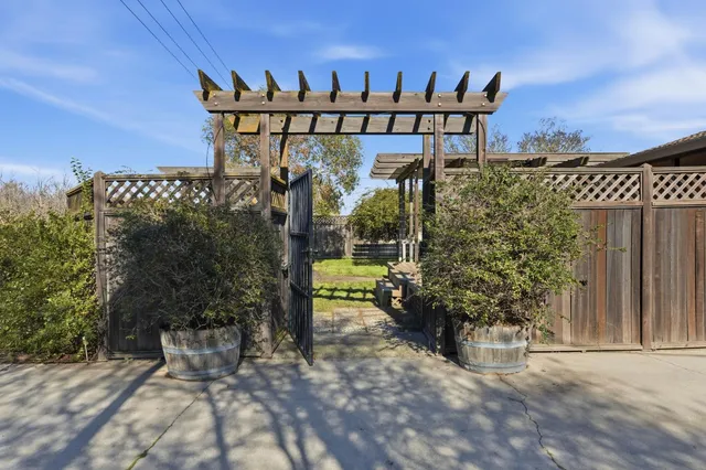 a view of a house with a yard and sitting area