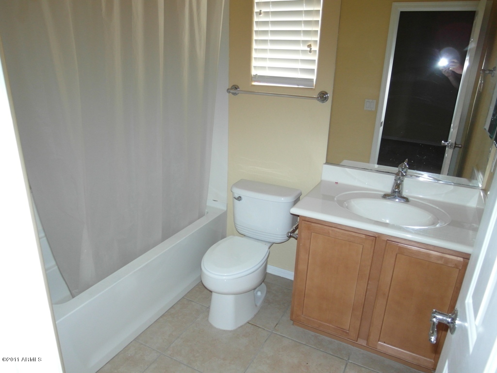 20779 West Ridge Road Buckeye, AZ 85396 - Photo 8 of 23 a bathroom with a toilet sink and mirror