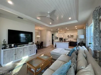 a living room with furniture large window and flat screen tv