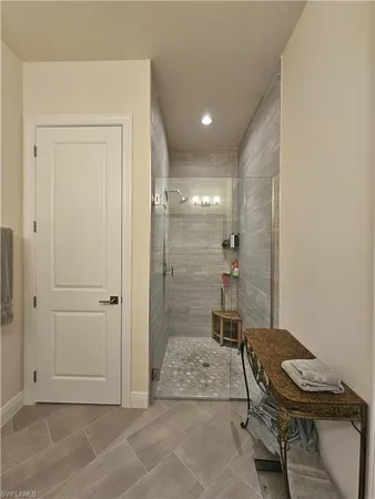 a spacious bathroom with a double vanity sink mirror and shower